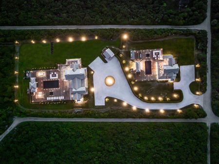 Welcome To The Dips. Aerial photo of the main and guest house at night.